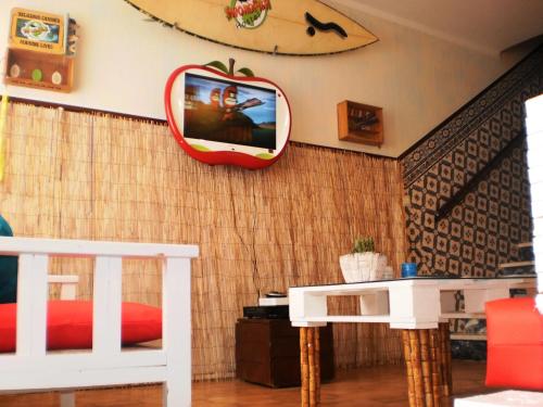 a room with a mirror and a bed and a table at SwordFish Eco-House Peniche in Peniche