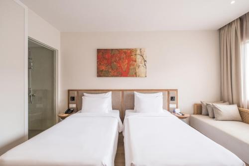 a hotel room with two beds and a couch at Minera Hot Springs Binh Chau in Binh Chau