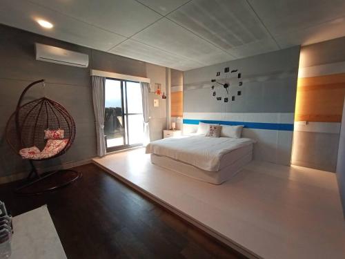 a bedroom with a white bed and a window at Sky Bird Garden B&B in Wujie