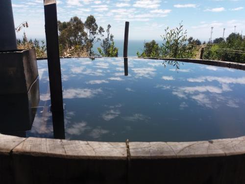 a reflection of the sky in a pool of water at Alto Curanipe in Pelluhue