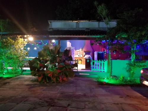 a house decorated with christmas lights in a yard at Pousada Miragem Do Mar Cabo Frio Praia Do Peró in Cabo Frio