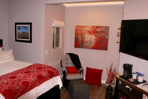 a bedroom with a bed and a chair and a television at Cathedral Casita at Sedona Cathedral Hideaway LLC in Sedona
