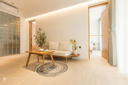 a living room with a couch and a table at CityHouse - CityOasis in Ho Chi Minh City