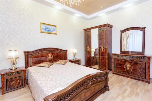 sypialnia z łóżkiem, komodą i lustrem w obiekcie Apartments in the historical center w Mińsku
