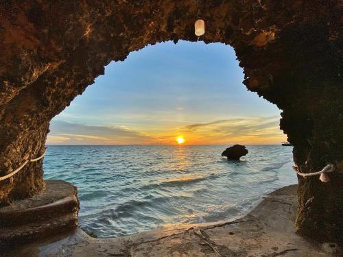 a view of the ocean through a stone archway at Jony's Beach Resort in Boracay