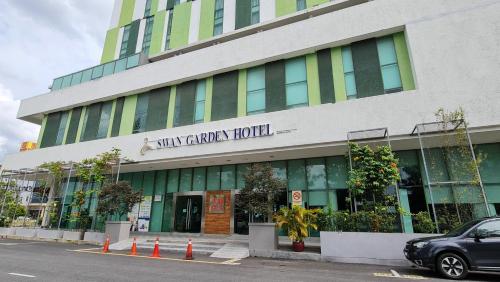 a car parked in front of a building at Swan Garden Hotel in Melaka