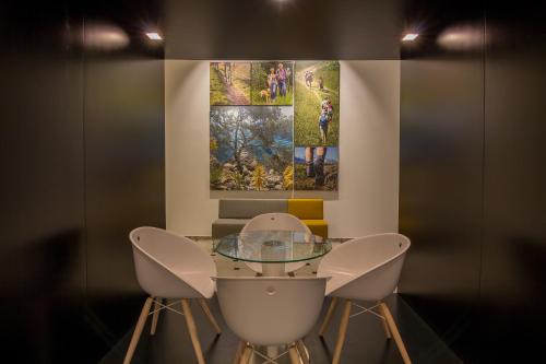 a dining room with a glass table and two chairs at Aparthotel Novo Mar in Paguera