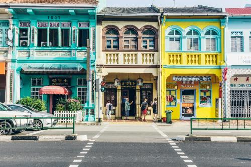 a street with colorful buildings on a city street at Village Hotel Katong by Far East Hospitality in Singapore