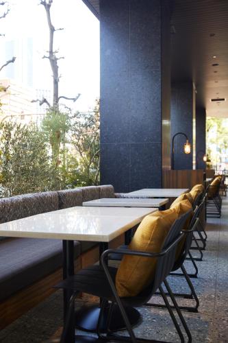 a row of tables and chairs in a restaurant at THE KNOT HIROSHIMA in Hiroshima