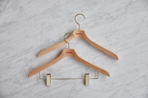 two wooden hangers hanging on a wall at THE KNOT HIROSHIMA in Hiroshima