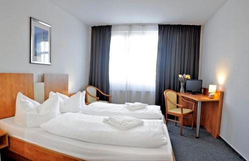 Ένα ή περισσότερα κρεβάτια σε δωμάτιο στο Apart Hotel Ferdinand Berlin
