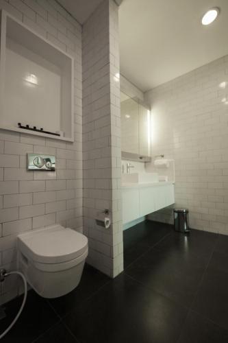 a bathroom with a toilet and a sink at Morrissey Hotel in Jakarta
