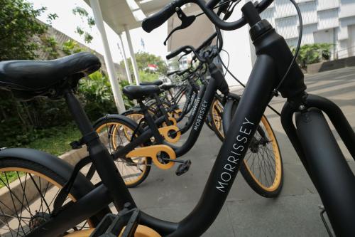 two bikes parked next to each other on a sidewalk at Morrissey Hotel in Jakarta