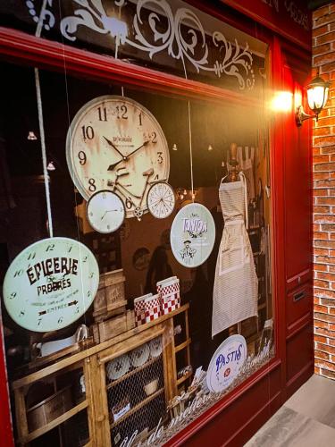 a store window with clocks and a dress in it at Journey Town Inn in Taipei