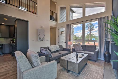 a living room with two couches and a table at Fire Pit, Deck and Mtn Views Upscale Pine Cabin! in Pine
