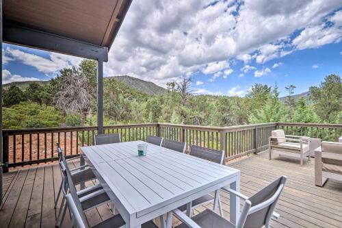 a white table and chairs on a wooden deck at Fire Pit, Deck and Mtn Views Upscale Pine Cabin! in Pine