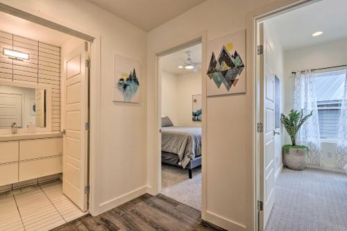 a bedroom with a bed and a bathroom at Fire Pit, Deck and Mtn Views Upscale Pine Cabin! in Pine