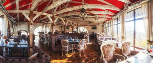 a dining car of a train with tables and chairs at Hotel Levitan in Vladimir