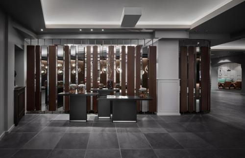 a room with two tables and a wine cellar at Schwarzer Adler Kitzbühel - Adults Only in Kitzbühel