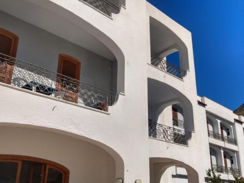 un edificio bianco con balconi e cielo blu di Villa Thomas BB a Ischia