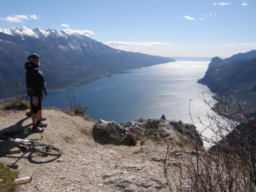 a man standing on top of a mountain overlooking a lake at Hotel La Fenice e Sole in Tremosine Sul Garda