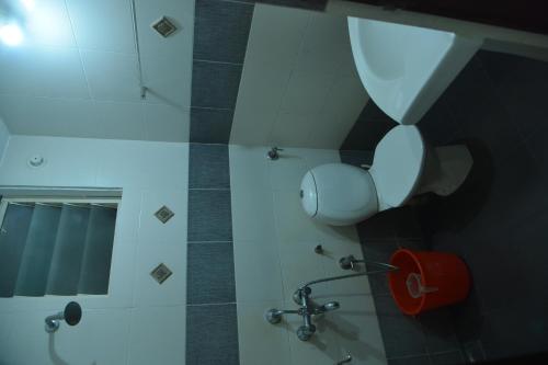 a bathroom with a toilet and a mirror at Emporium Hotel in Mangalore