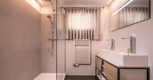 a bathroom with a shower and a sink at Seeblick Davos in Davos