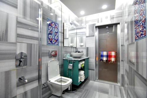 a bathroom with a toilet and a sink at Angel's Home Suites - Angel Group Hotels in Istanbul