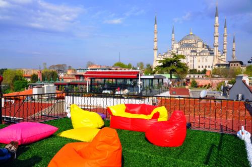 a playground with colorful chairs and a mosque in the background at Angel's Home Suites - Angel Group Hotels in Istanbul