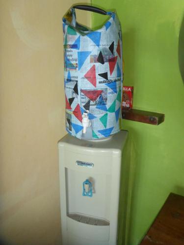 a water tank on top of a refrigerator with a stained glass at Oliver`s Laguna ECO Lodge Hotel in Ngapali