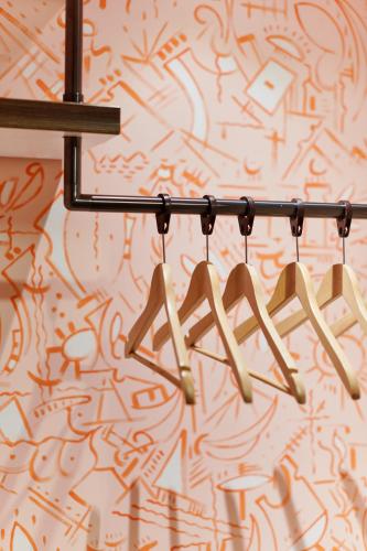 a group of wooden hangers hanging from a wall at art Hotel Tucholsky in Bochum