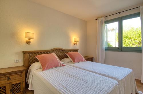 En eller flere senge i et værelse på Xalet prat xirlo