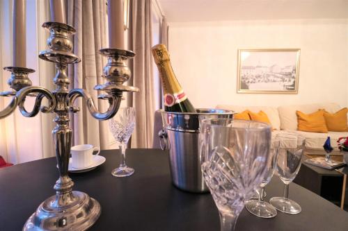 a table with a bottle of champagne and glasses on it at Brodderud Apartments in Mariestad