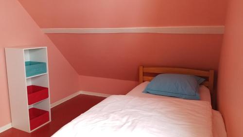 a small bedroom with a bed and a book shelf at Gîte de montagne du Plateau de Lhers- Accueil randonneurs in Accous