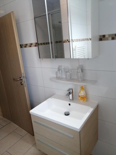 a bathroom with a white sink and a mirror at Hotel-Restaurant Zum Bäumle in Süßen