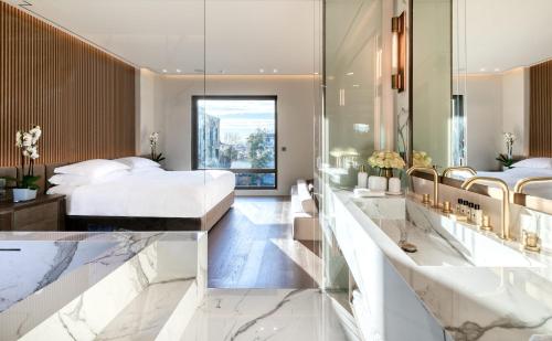 a bedroom with a king sized bed and a large mirror at The One Acropolis in Athens