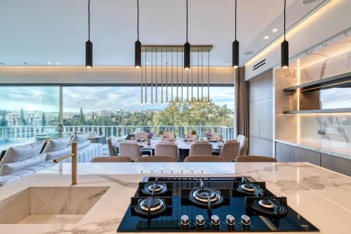 a kitchen and dining room with a view of the city at The One Acropolis in Athens