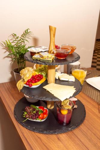 a three tiered tray of food on a table at LOK - Die Pension - Das Restaurant in Tessin