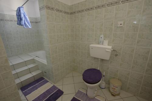 La salle de bains est pourvue de toilettes et d'une baignoire. dans l'établissement Villa Sunshine, à Ukunda