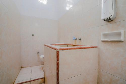 a bathroom with a shower and a toilet in it at RedDoorz Plus near Tapal Kuda Cugenang Cianjur in Cianjur
