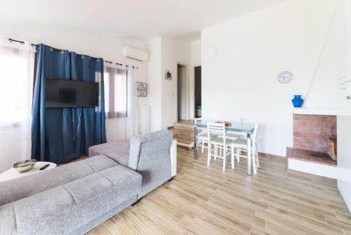 a living room with a couch and a table at VILLA ALOE in Costa Paradiso