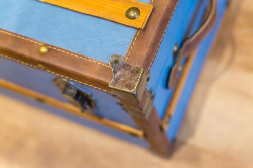 a close up of a blue bag with a metal latch at La Gatta Cenerentola Rooms in Naples