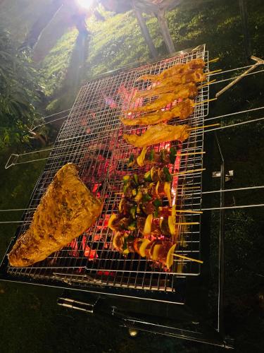 a grill with a bunch of food on it at Tiên Sơn Pleiku Homestay in Pleiku