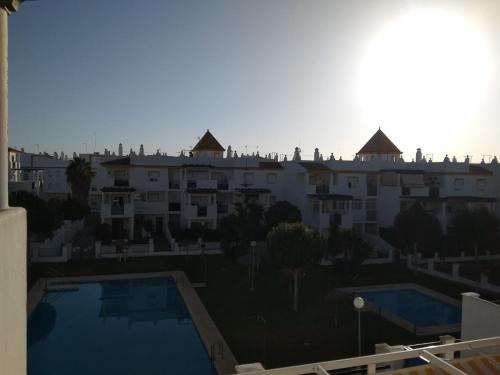 a view from the balcony of a building with two swimming pools at Apartamento La Atalaya C-162 in Conil de la Frontera