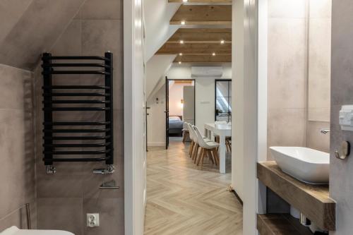 a bathroom with a sink and a tub and a toilet at TatryTop Apartamenty Alpejski SPA in Kościelisko