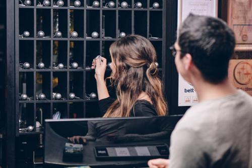 a man and a woman standing in front of a wine rack at art Hotel Tucholsky in Bochum