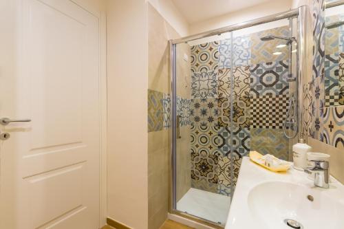 a bathroom with a shower and a sink at La Gatta Cenerentola Rooms in Naples