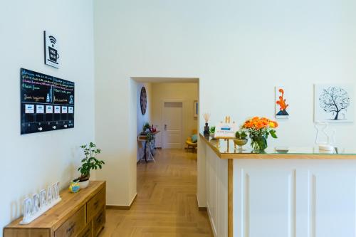 a living room with a counter and a hallway at La Gatta Cenerentola Rooms in Naples