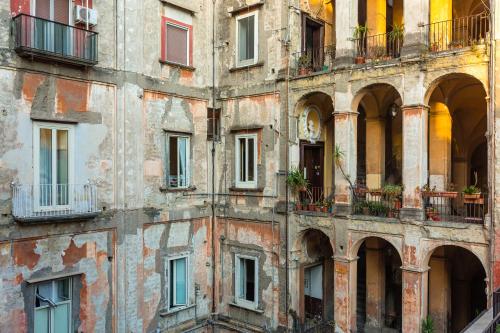 an old building with lots of windows and balconies at La Gatta Cenerentola Rooms in Naples