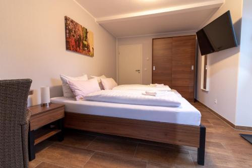 a bedroom with a large bed and a television at Motel Am Bürgerpark in Werlte